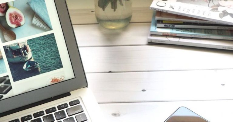 Data Utilization - Macbook Air, Flower Bouquet and Magazines on White Table