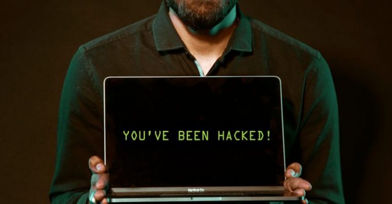 Cybersecurity Measures - Man Holding Laptop Computer With Both Hands